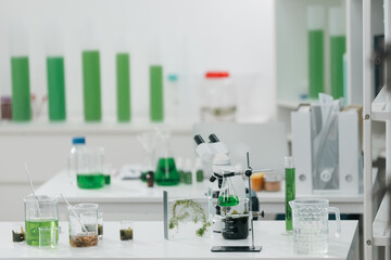Scientists examining plant and algae samples in a modern laboratory, conducting pharmaceutical...