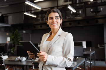 Smiling young businesswoman entrepreneur saleswoman working on touchscreen computer device....