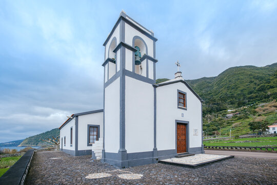 Chapel of Sao Sebastiao, Faja dos Vimes, Sao Jorge, Azores, Portugal. Picturesque Island Church with Bell Tower and Ocean View. Ideal for travel and religious themes.