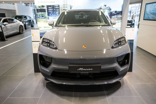 electric Porsche Macan displayed in showroom, eco-friendly dynamic styling and high-performance characteristics, Frankfurt - January 25, 2025
