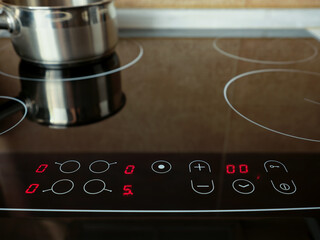 Close-up of control panel of modern electric cooking stove.