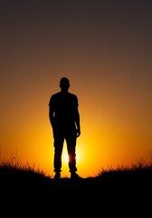 Silhouette of a Person Standing Against Sunset