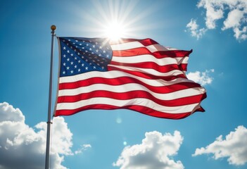 American flag waving against a bright blue sky with sun rays shining