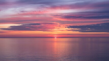 Fototapeta premium Majestic sunset over the ocean with vibrant colors reflecting on the water surface