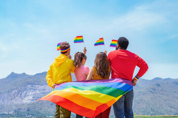 lgbt with pride flag waving in the air,talking,smiling and hugging together,happy group of...