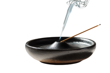 Burning incense stick with aromatic smoke in a black ceramic holder, white isolate background