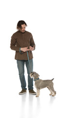 Man walking with purebred Miniature Schnauzer isolated on white background. Calm and smart dog. Concept of domestic animals, pet care, vet. Copy space for ad