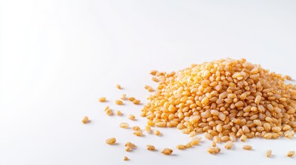 Close-up of a pile of roasted and toasted sesame seeds spread on a white background with scattered seeds for healthy snack or culinary ingredient concept