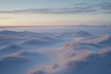 Obraz premium Sunrise over a vast, snowy, windswept plain. Gentle dunes covered in frost