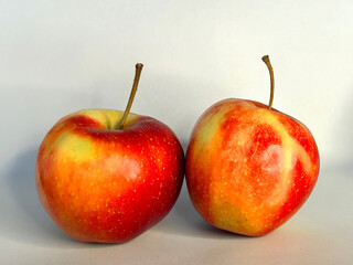 Colorful apples arranged artistically on a neutral background, showcasing vibrant red and yellow...