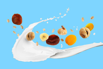 Milk splash with oat flakes and dried fruits on light blue background. Healthy breakfast