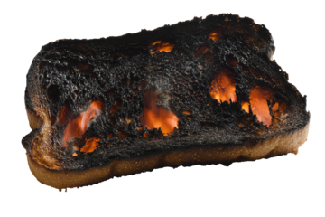 Severely burnt bread slice with glowing embers