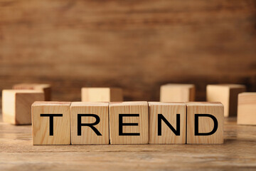 Word Trend made of wooden cubes with letters on table