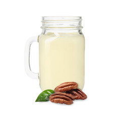 Nut milk in glass jar and pecans isolated on white