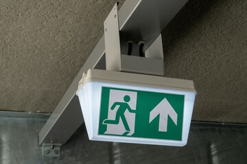 Emergency exit sign showing safe egress route in building