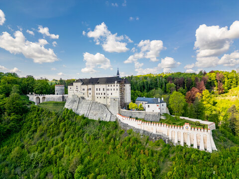 Aerial panoramic view of Cesky Sternberk Castle (Cesky Sternberk, Bohemian Sternberg) surrounded by forested hills and the Sazava river during summer in Czech Republic