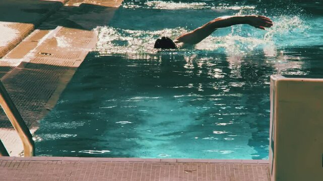 An unknown freestyle swimmer in water in the swimming pool