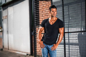handsome athletic young man standing on the street