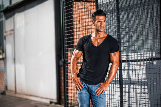 handsome athletic young man standing on the street