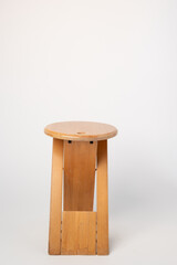 Small, folding, used wooden stool that can also serve as a side table,.