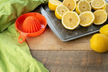 Lemons cut in halves on a baking sheet, preparing to make lemonade.
