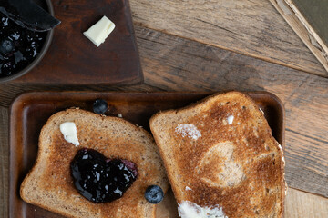 Whole wheat toast with fresh blueberry jelly in a rustic kitchen.