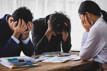 Business people feeling stressed and frustrated from work in office. Team of business people is...