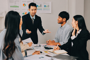 Team of financial advisory services. Asian advisor showing plan of investment to clients in the consultancy office..