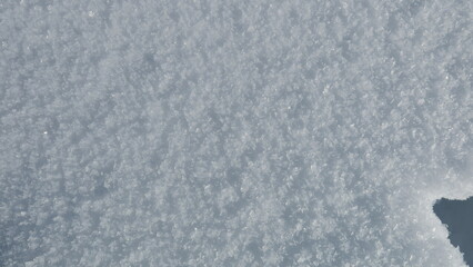 High-resolution image of pristine snow crystals, perfect for winter backgrounds or textures.