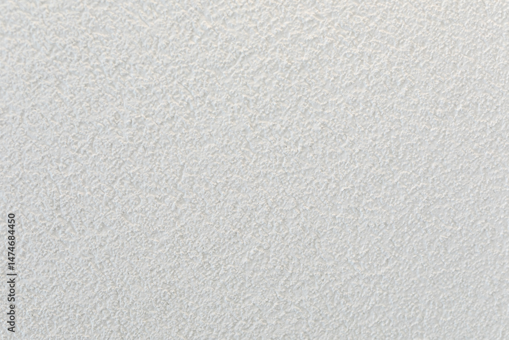 Poster high-resolution image of a white textured wall, perfect for backgrounds and design projects.