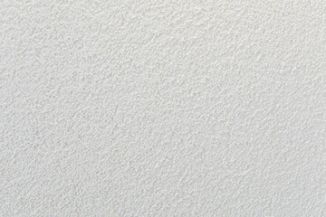 High-resolution image of a white textured wall, perfect for backgrounds and design projects.