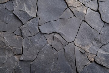 Weathered basalt stone background with cracks, perfect for textures or natural surfaces.