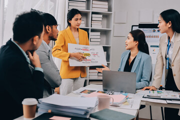 Team of financial advisory services. Asian advisor showing plan of investment to clients in the consultancy office..