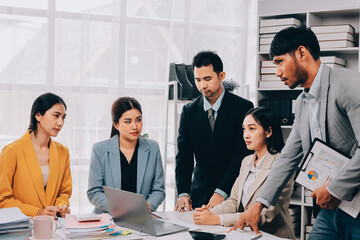 Team of financial advisory services. Asian advisor showing plan of investment to clients in the consultancy office..