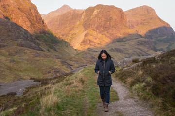 Woman walking in the mountains, glencoe, Scottish Highlands