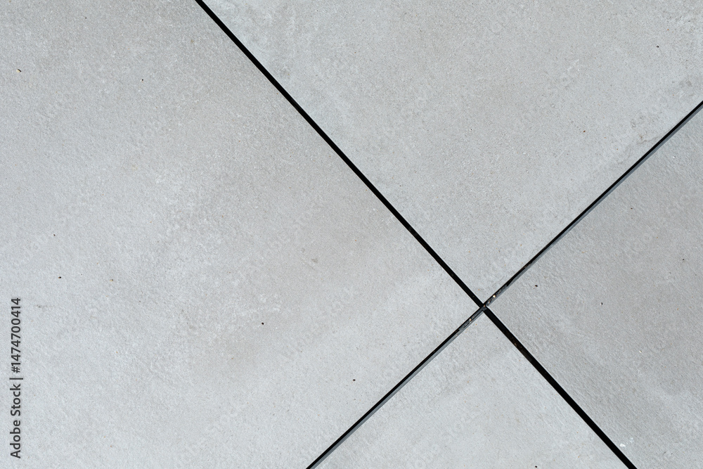 Poster Abstract background texture of grey concrete tiles intersecting at the center with thin black lines. Perfect for modern design.