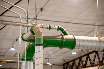 Industrial HVAC metal Pipe header with multiple connections in a production facility with a coating...