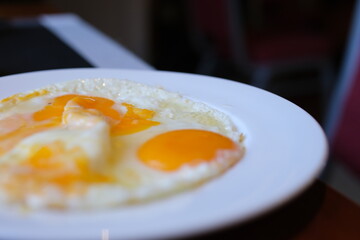 Sunny-side eggs plate two Fried eggs in the plate close up ,