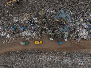 Trucks are collecting waste in large piles for disposal and recycling.