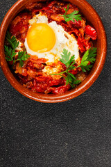 Fried egg tomatoes shakshuka vegetable dish appetizer fresh delicious gourmet food background on the table rustic food top view copy space vegetarian  food