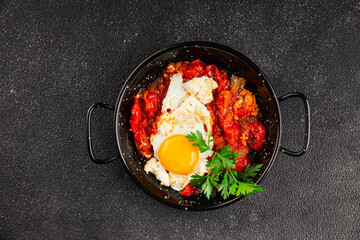 Fried egg tomatoes shakshuka vegetable dish appetizer fresh delicious gourmet food background on the table rustic food top view copy space vegetarian  food