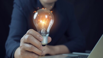 Innovation. Hands holding light bulb for Concept new idea concept with innovation light bulb looking for a new idea for a better working design.