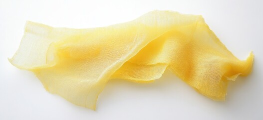 Pale yellow, translucent sheets of food, likely processed or dried