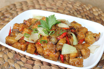 Restaurant menu stir-fried tempeh with soy sauce seasoning