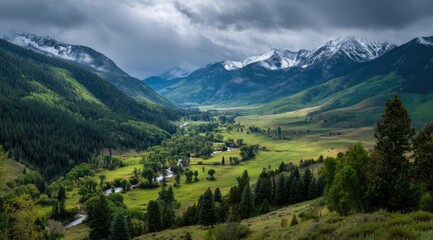 Fototapeta premium Mountain valley bathed in soft light, under a dramatic sky. Lush green meadows, flowing river, and snow-capped peaks create a breathtaking panorama