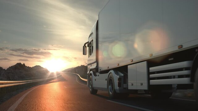 A long distance semi truck with cargo trailer passes the camera driving on a desert road into the sunset. Low angle camera. 3d animation rendering.