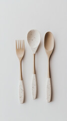 3 beige kitchen utensils on a white background