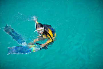 Woman tourist in seawater in moment practice free diving topup skill junior