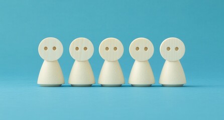 Five Small White Figures in a Row Against a Blue Background
