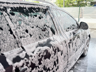 Close-up of a car in foam at a car wash